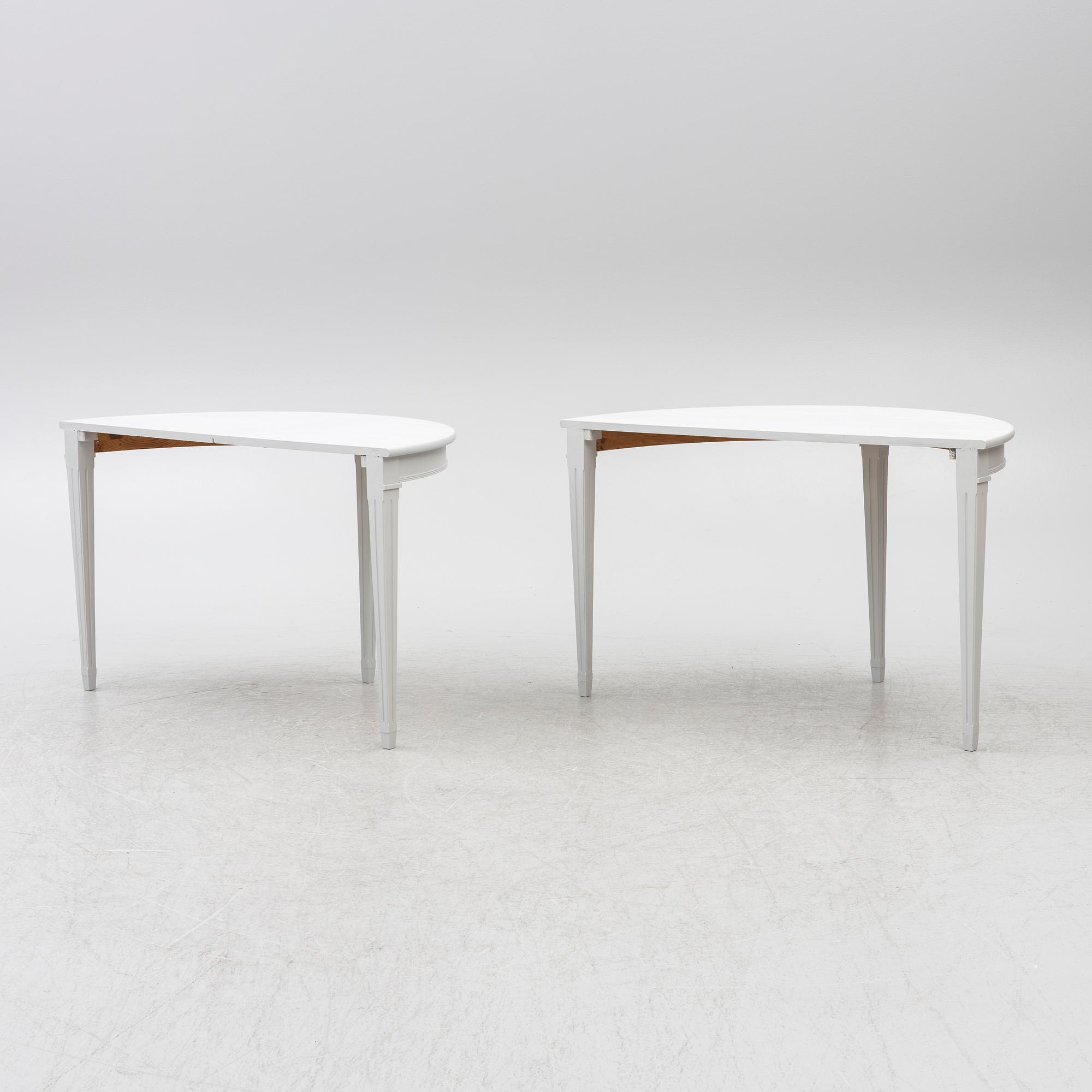A pair of crescent shaped tables, 20th century.