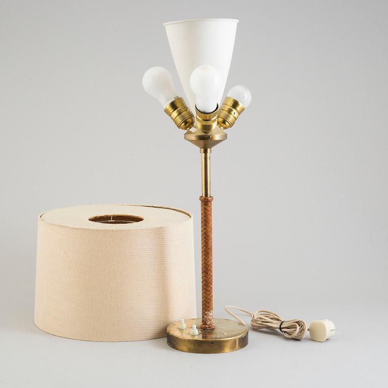 A brass and leather table light from Nordiska Kompaniet, mid 20th Century.