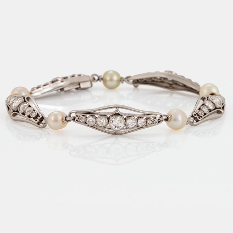 A platinum bracelet set with old-cut diamonds and pearls.