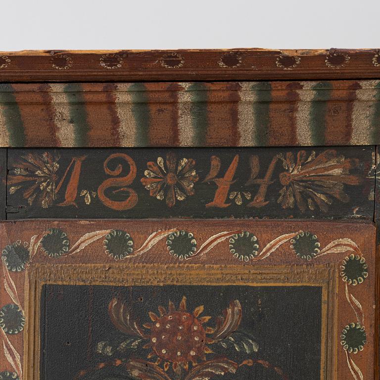 A corner hanging cabinet, dated 1844.
