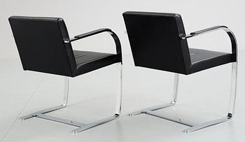 A pair of Ludwig Mies van der Rohe 'Brno' black leather and steel armchairs, Knoll International, USA.