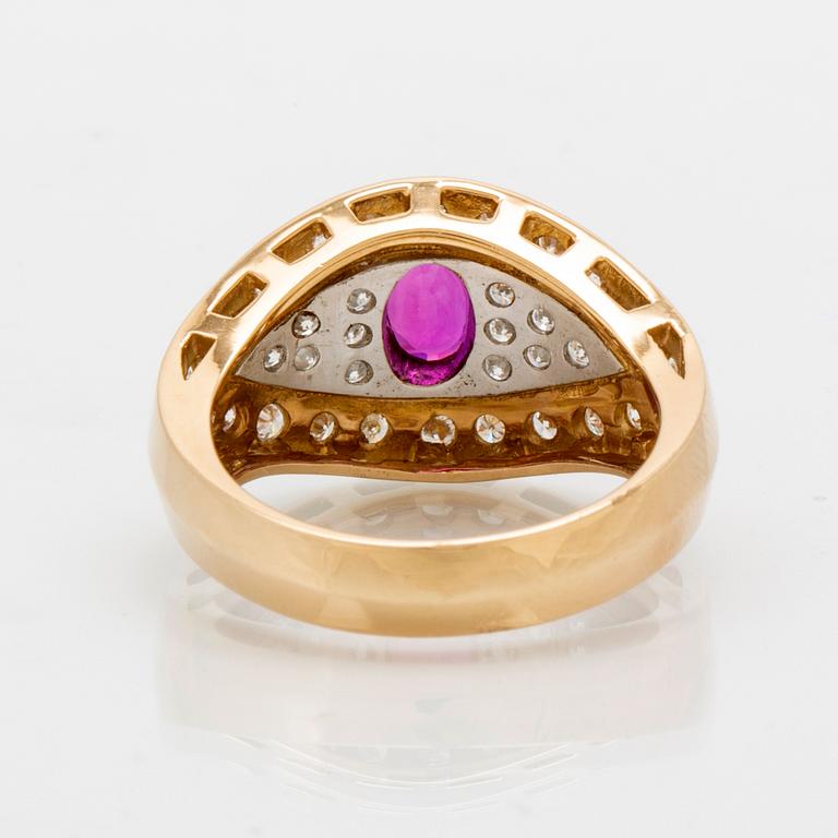 An 18K gold and platinum ring with diamonds and a ruby.