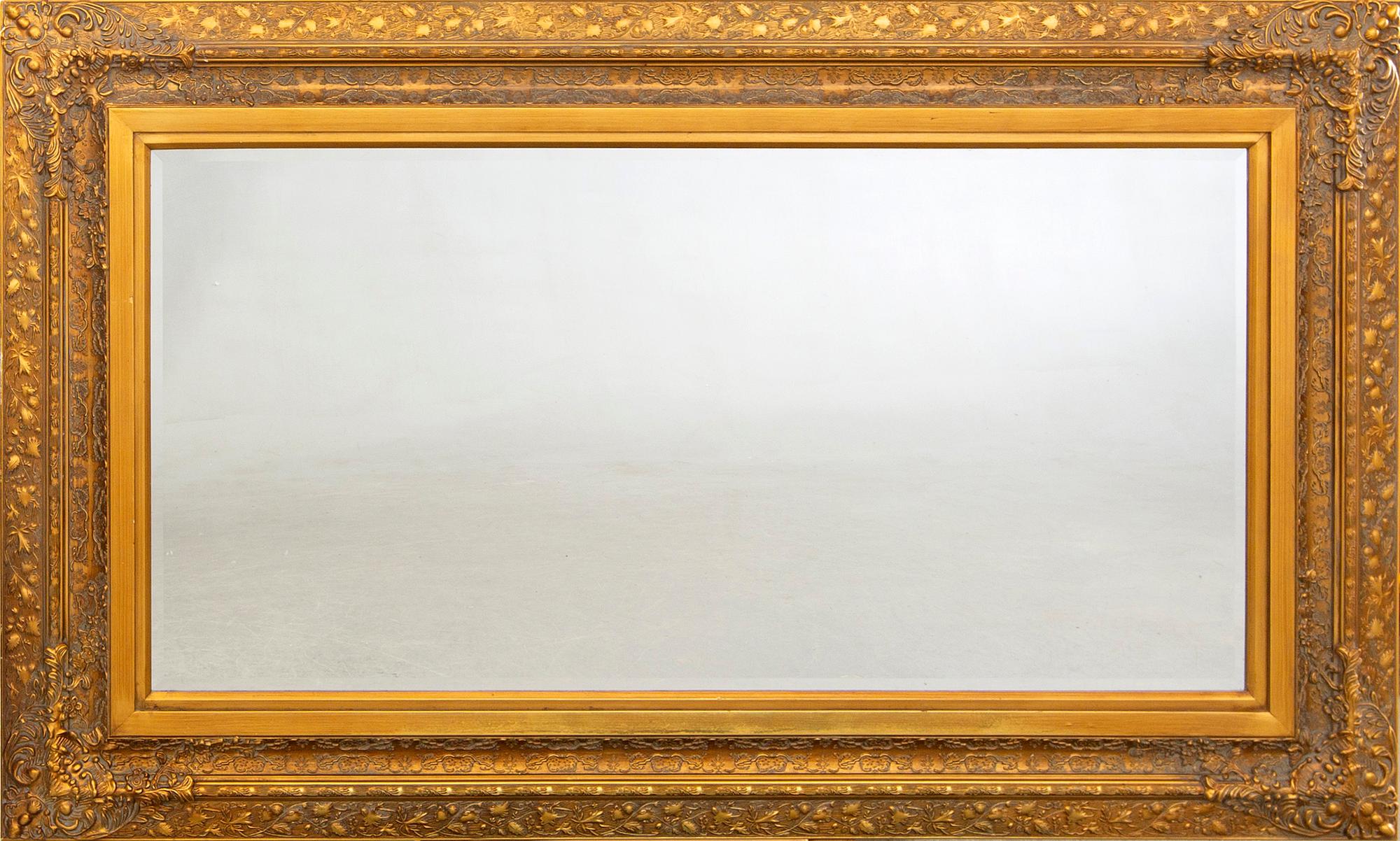 A gilded mirror later part of the 20th century.