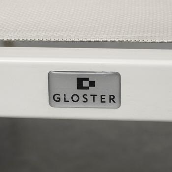 A garden table with four chairs, Gloster.