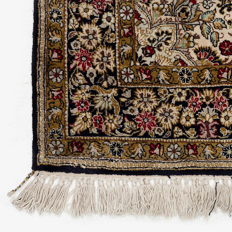 A Ghom silk rug, c. 158 x 105 cm.