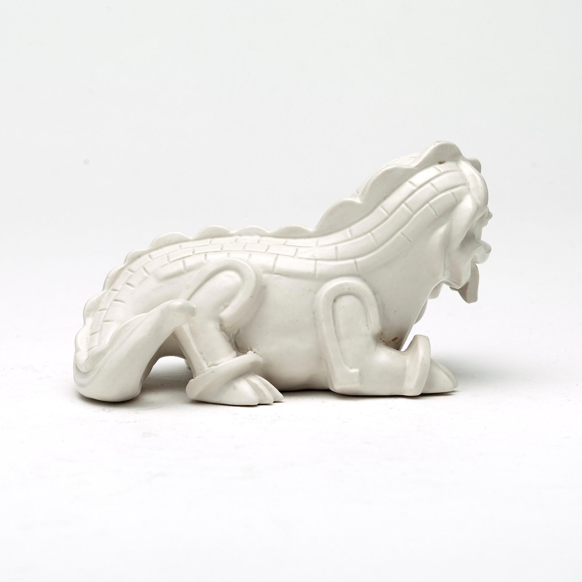 Wilhelm Kåge, a set of stoneware figures of a 'dragon puppy' and two 'dragon puppies' with candle holders, Gustavsberg, ca 1940.