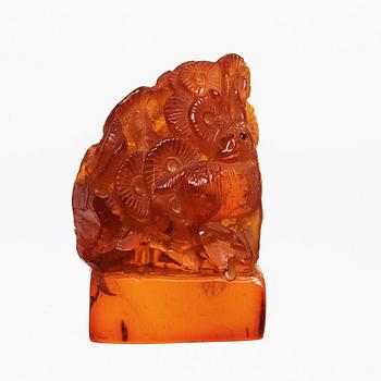 An amber sculpturein the shape of a fawn and a bird amongst pine trees, Qing dynasty (1644-1912).