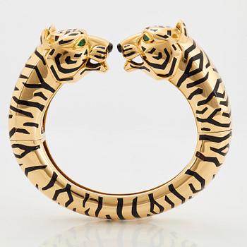 Cartier "Panthère" an 18K gold and enamel bracelet set with emeralds.