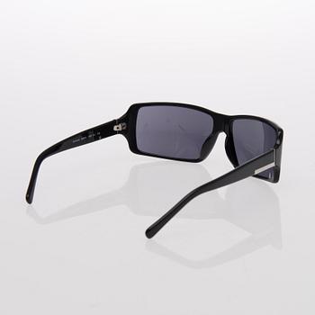 Two Pairs of Sunglasses, Prada and Chanel.
