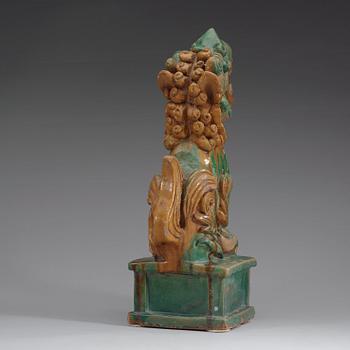 A green and yellow glazed pottery figure of a buddhist lion, presumably Ming dynasty.