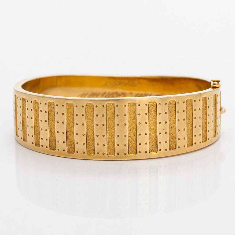 Kalevala Koru, armband, "Metsäpirtti", 18K guld. Helsingfors 1957.