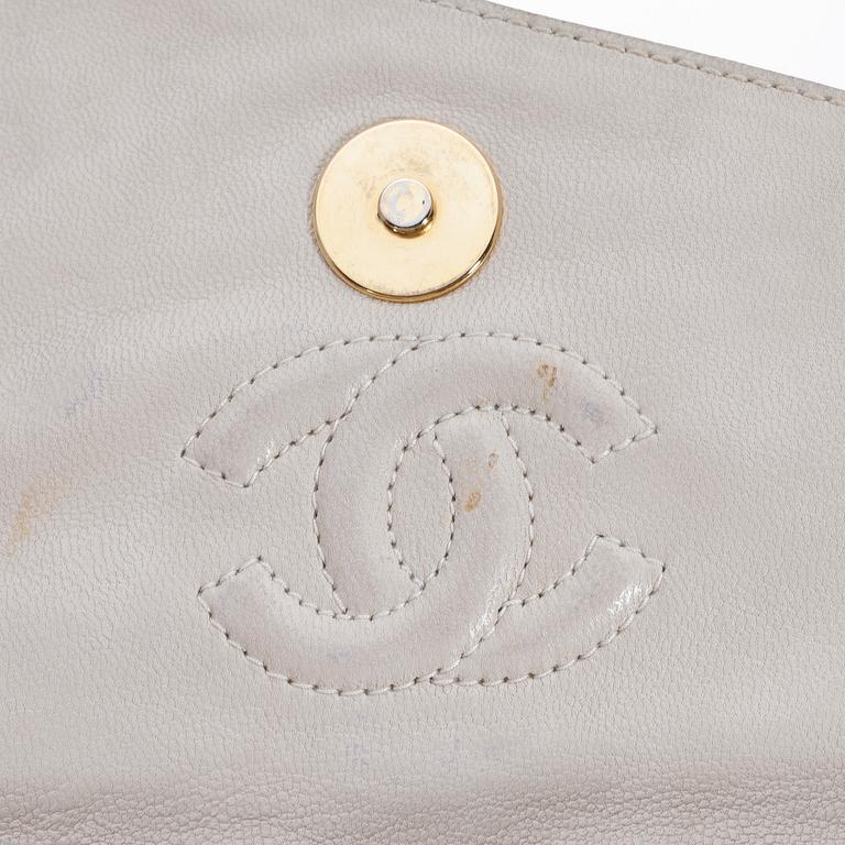 A beige shoulder bag by Chanel.