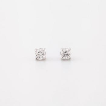 A pair of brilliant cut diamond earrings.