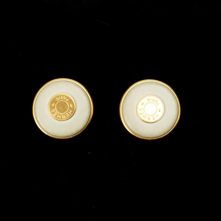 A pair of earrings by Hermès.