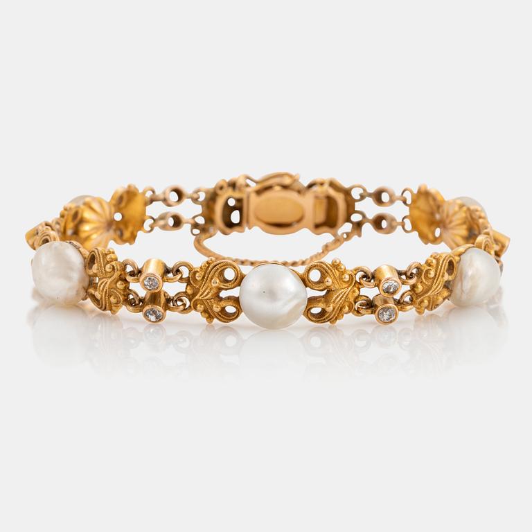 A 14K gold bracelet set with pearls, possibly natural, and old-cut diamonds.