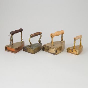 FOUR 19TH CENTURY BRASS IRONS.