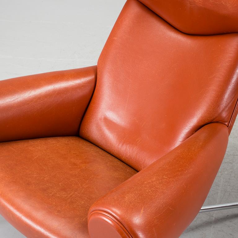 An "Ox-Chair" and foot stool by Hans J Wegner for Erik Jorgensen, Denmark.
