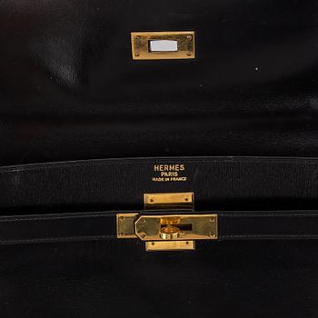 Hermès,a black leather 'Kelly 32' handbag, 1975.