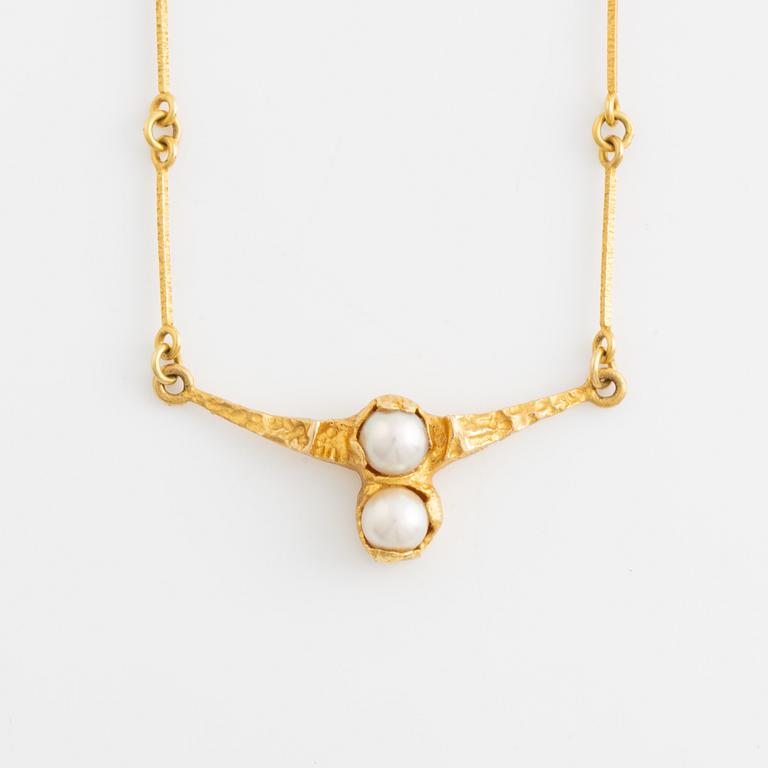 An 18K gold necklace set with a cultured pear, Björn Weckström for Lapponia.