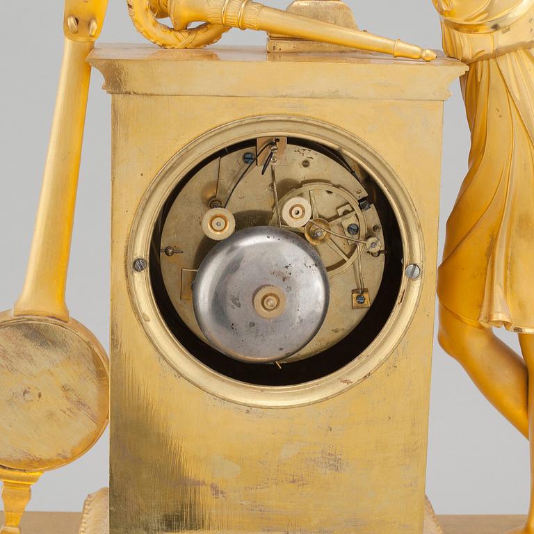 An Empire table clock, dial marked "L Ravrio Bronzier à Paris Mesnil H", fist half of the 20th century.