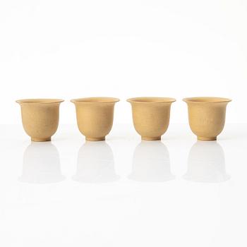A set of a yellow yixing 'gongfu' teapot and four cups, China, 1980s.