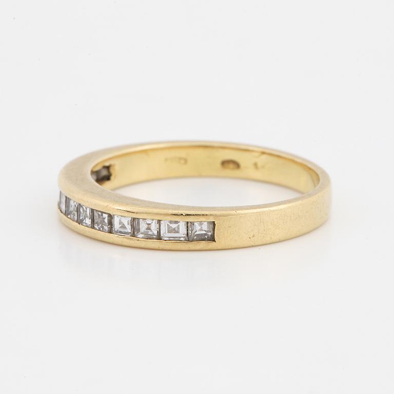 Step-cut diamond ring.
