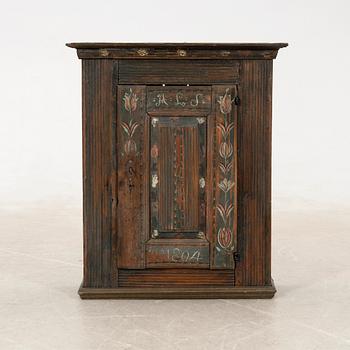 Wall-mounted cabinet dated 1804.