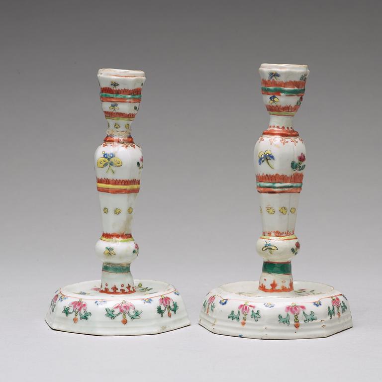 A pair of famille rose candle sticks, Qing dynasty, Qianlong (1736-95).