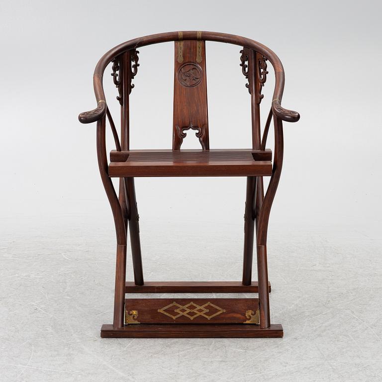 A Chinese hardwood folding chair, 20th century.