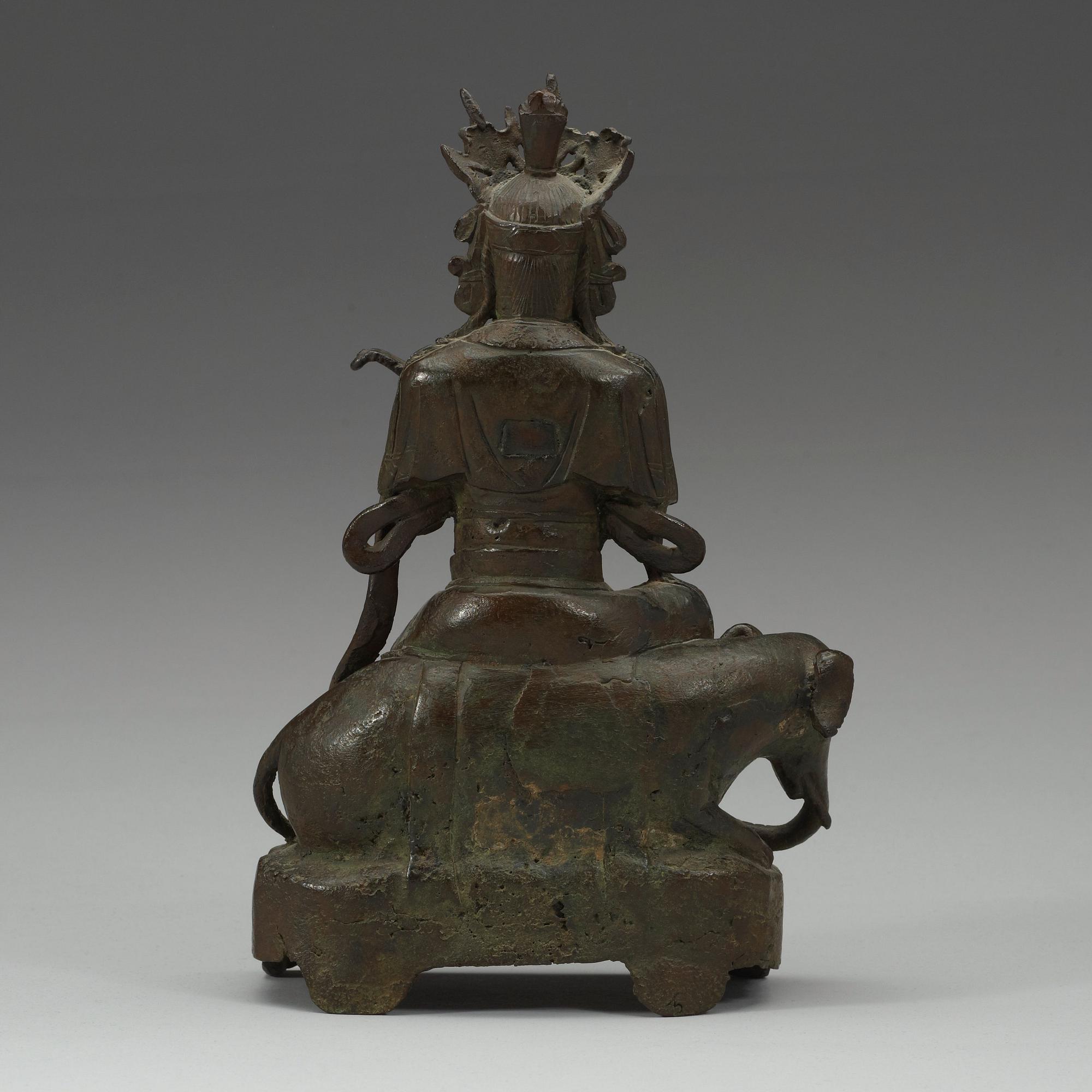 A seated bronze figure of Guanyin on an elephant, Qing dynasty, 19th Century.