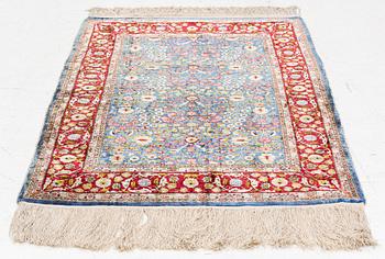 An Oriental silk rug, signed, c. 125 x 85 cm.