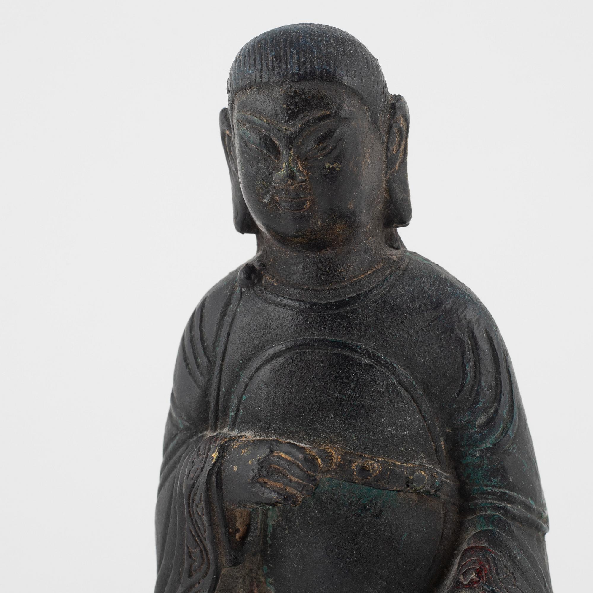 A bronze sculpture of a seated deity, Ming style, probably 20th Century.