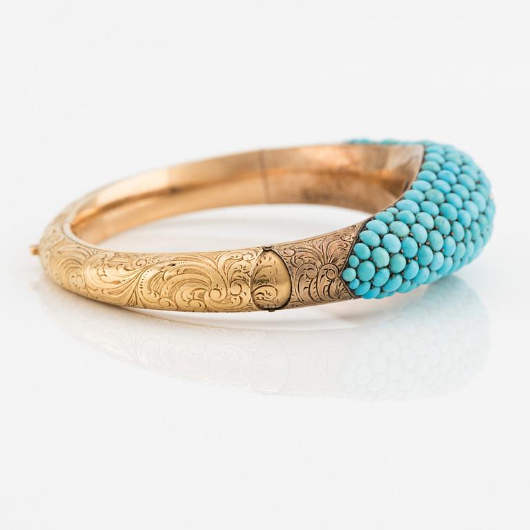 An 18K gold bracelet with turquoises and an old-cut diamond.