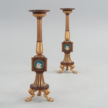 A pair of Empire 19th century candle stands.