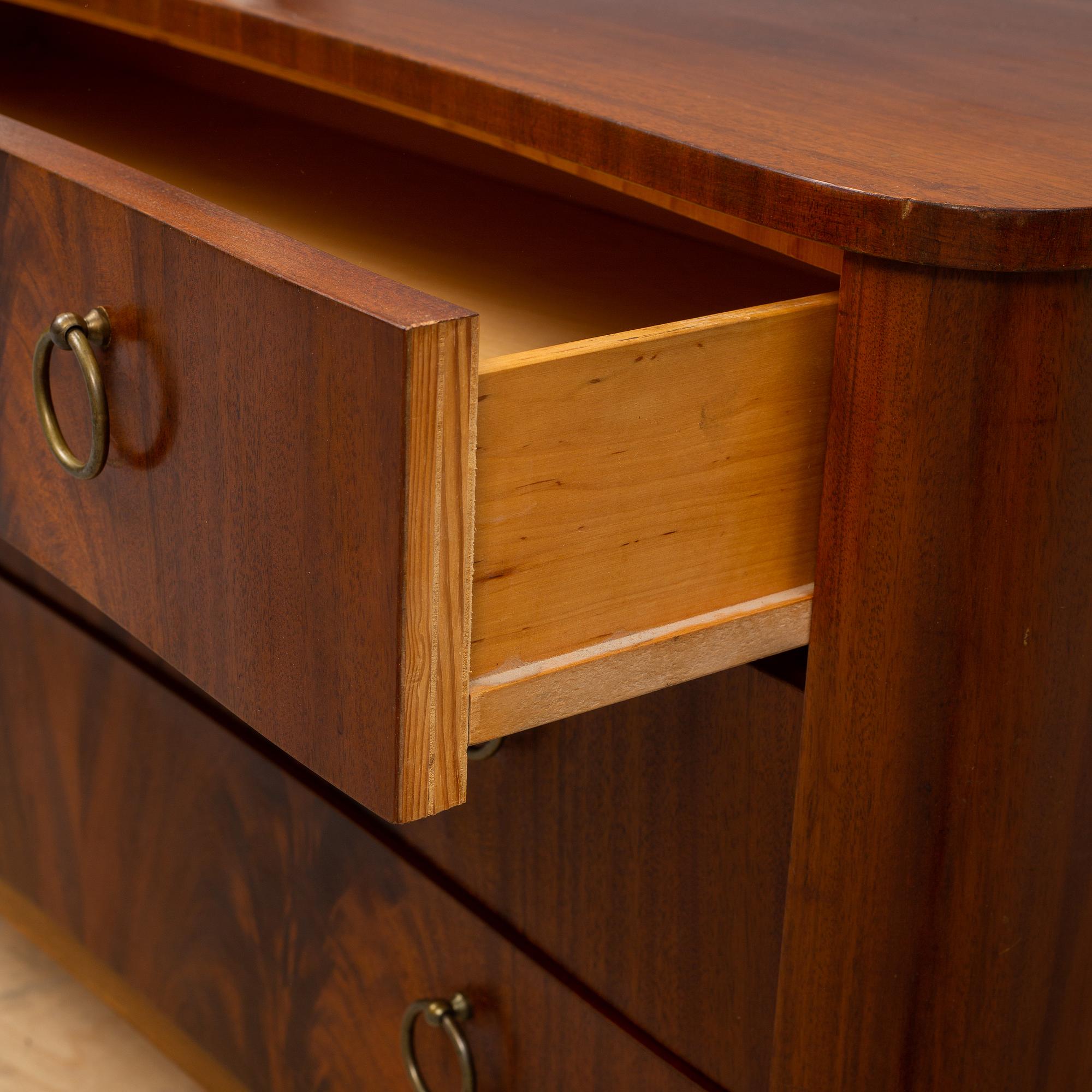A 1940s Swedish Modern mahogany veneered chest of three drawers.