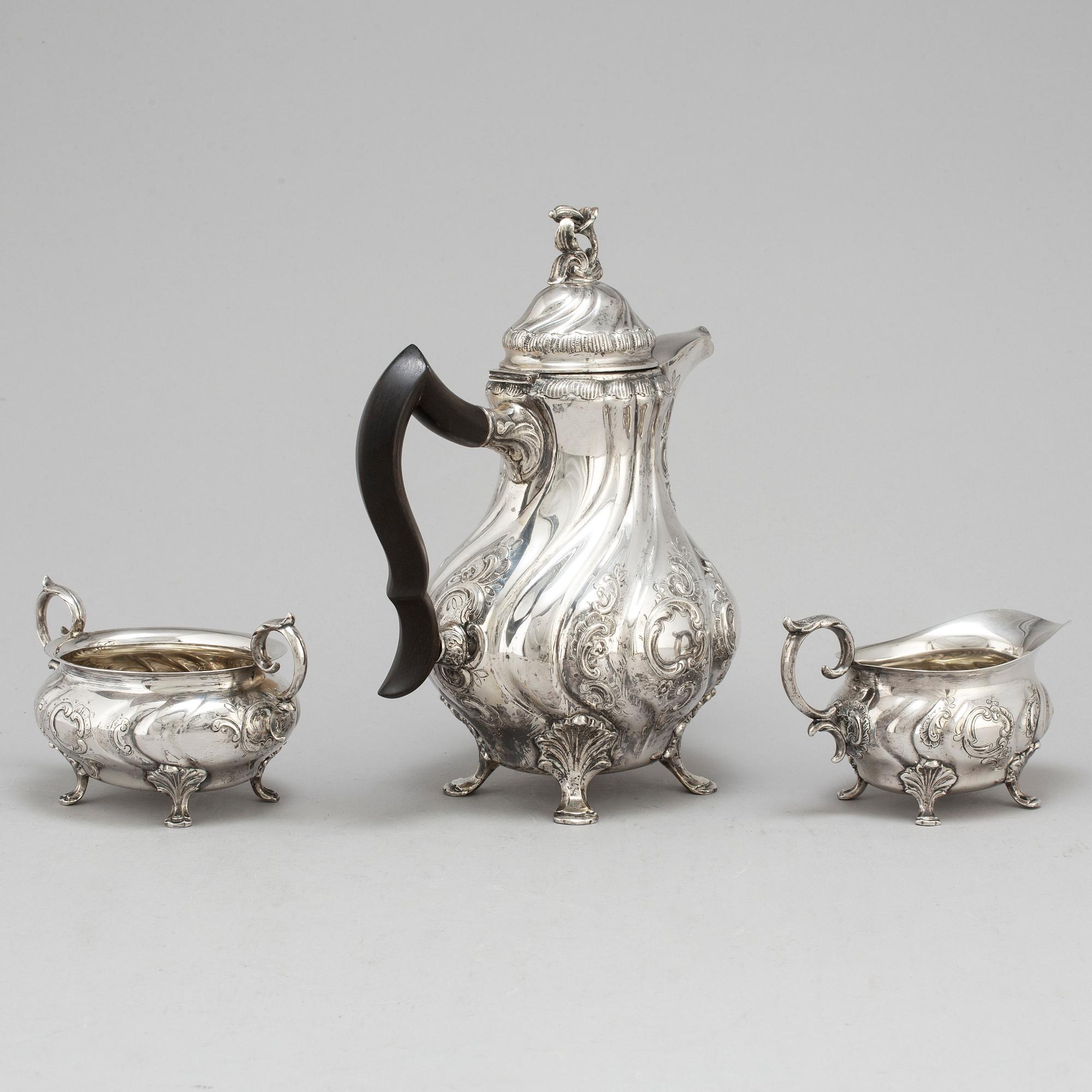 A three-piece silver rococo style coffee service by CG Hallberg, Stockholm, 1948.