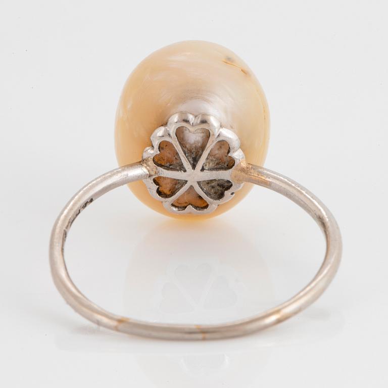 An 18K white gold ring set with a pearl, most likely natural.