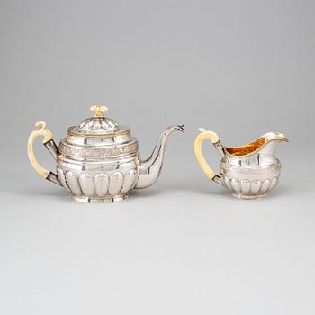 A Russian silver teapot and a parcel gilt silver creamer, Gustav Lindgren and Elias Modig, St Petersburg 1826-27.