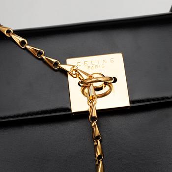 CÉLINE, a black leather top handle purse.