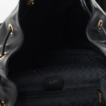 Gucci, A black leather backpack.