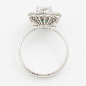 Ring 18K white gold set with a step-cut emerald and round brilliant-cut diamonds.