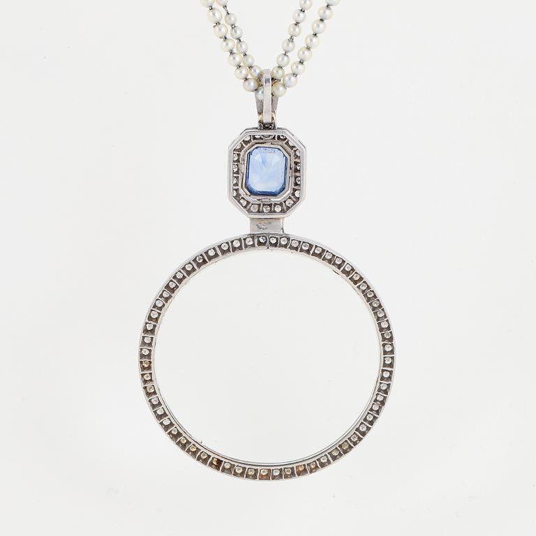 A platinum lorgnette set with a faceted sapphire and rose-cut diamonds.