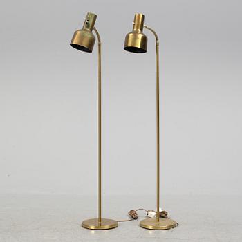 A pair of brass floor lamps, "MAE 27".