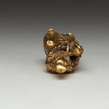A seated gilt bronze figure of Guanyin with a small boy, Qing dynasty, 18th Century.