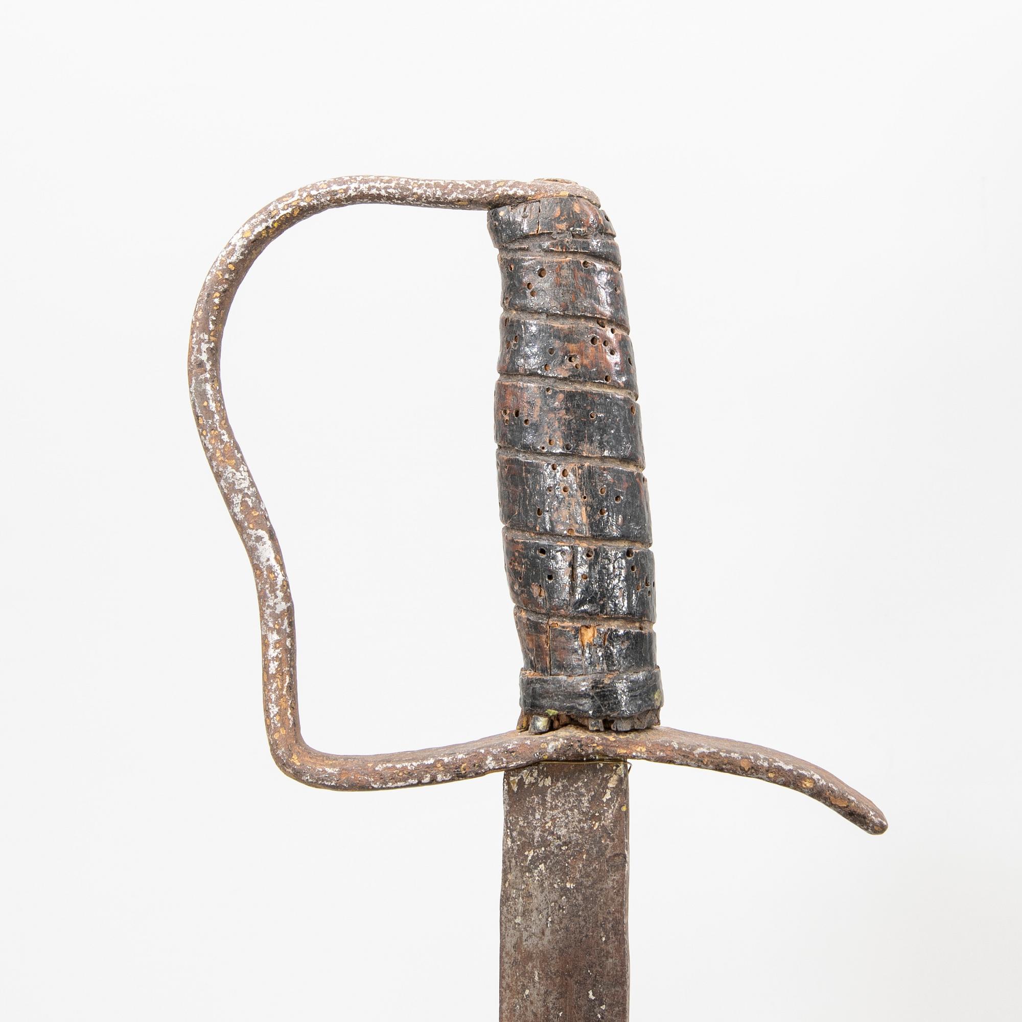 A German sabre with scabbard and a cutlass.