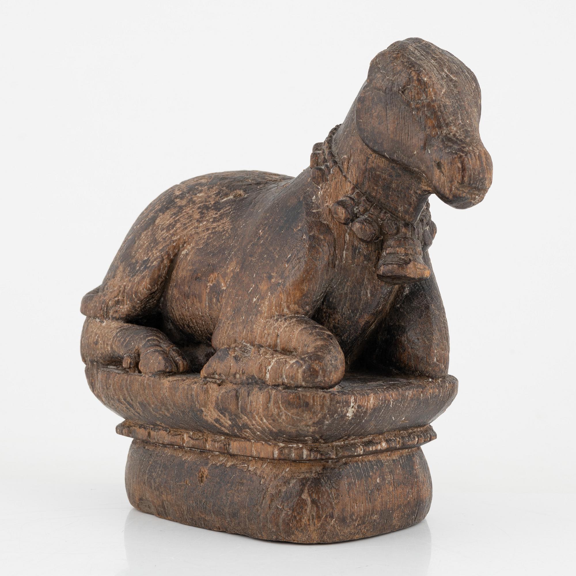 A wooden sculpture of a cow.