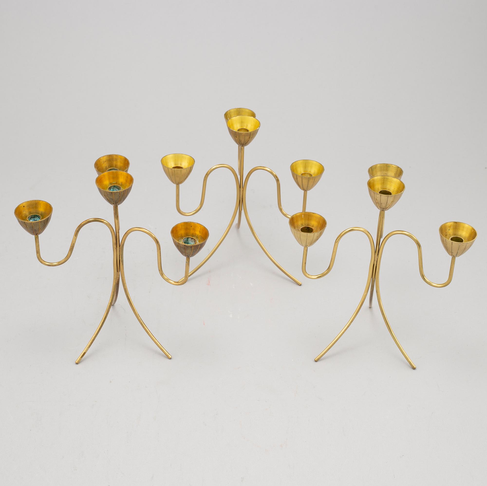 Gunnar Ander, a set of three brass five-light candelabra from Ystad Metall.