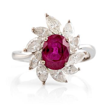 582. A ring set with a faceted ruby and navette-cut diamonds.