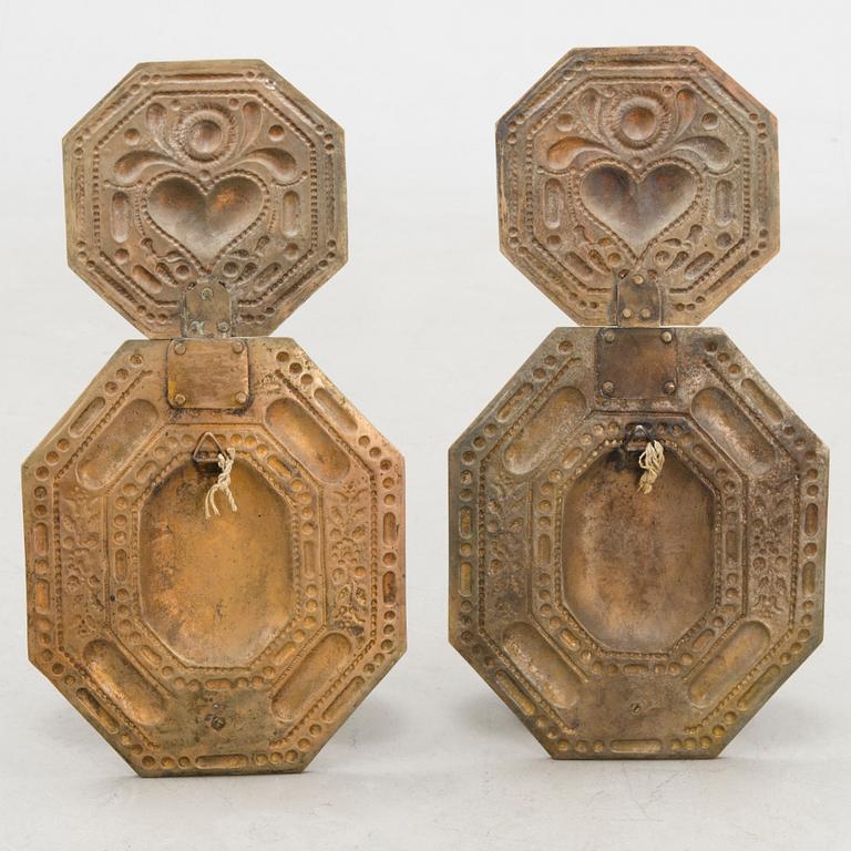 A pair of bronze wall scones from the early 20th Century.