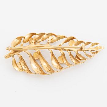 Brooch 18K gold with blue stones.